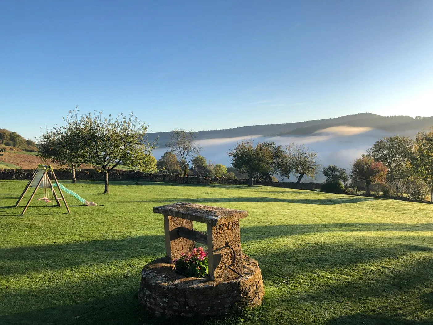 The well in the garden, early-morning mist in the valley