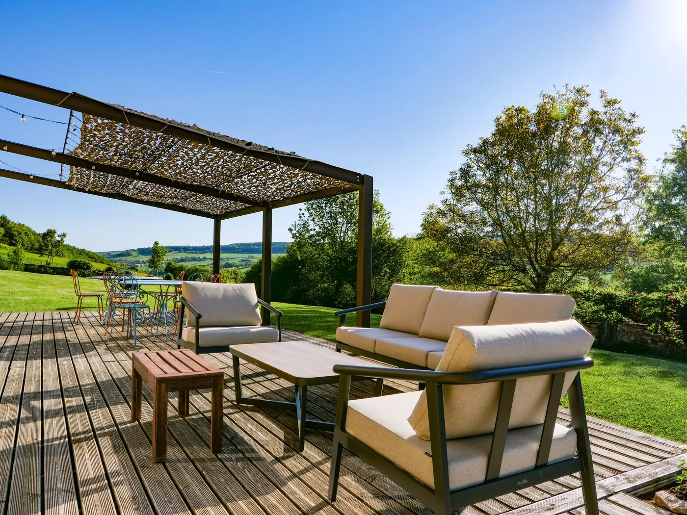 Garden seating under the pergola, looking out over the hills