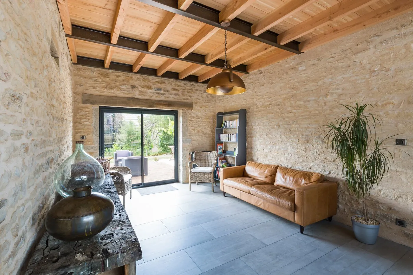 The sitting room, with stone walls and a leather sofa